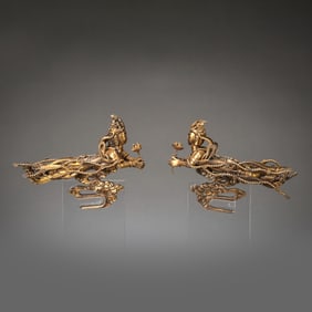 A pair of Chinese Liao Dynasty gilded flying figures