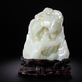 A Chinese Qing Dynasty Hetian white jade carving in the shape of a mountain
