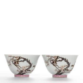 A pair of Chinese Qing dynasty famille rose cups with flower and bird designs