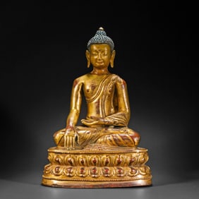 A Chinese Ming Dynasty gilt bronze statue of a seated Buddha