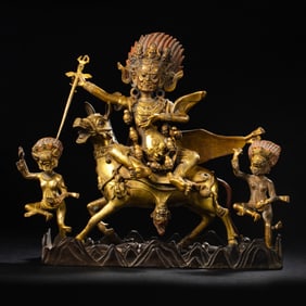 A Chinese Qing Dynasty gilt bronze statue of a seated Buddha