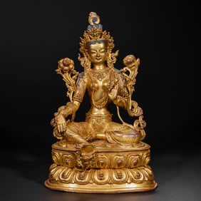 A Chinese Qing Dynasty gilt bronze statue of a seated Buddha