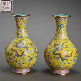 A pair of Chinese Qianlong-period famille rose vases with dragon designs