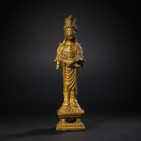 A Chinese Liao Dynasty gilt-bronze standing Buddha statue