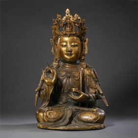 A Chinese Ming Dynasty gilt bronze statue of a seated Buddha