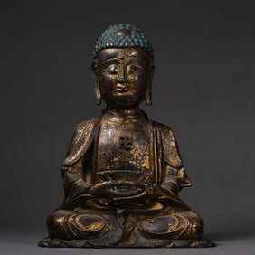 A Chinese Ming Dynasty gilt-bronze statue of seated Sakyamuni Buddha