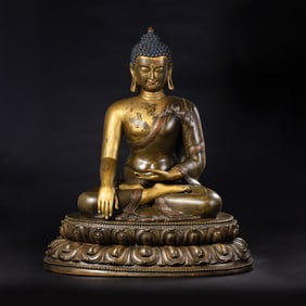 A Chinese Ming Dynasty gilt bronze statue of a seated Buddha