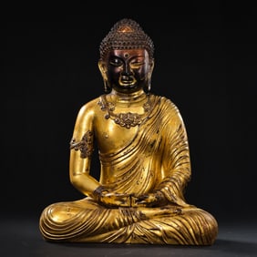 A Chinese Ming Dynasty gilt bronze statue of a seated Buddha
