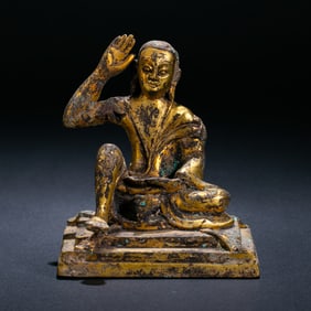 A Chinese Ming Dynasty gilt bronze statue of a seated Buddha