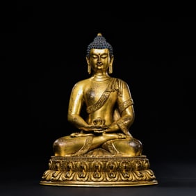 A Chinese Qing Dynasty gilt bronze statue of a seated Buddha
