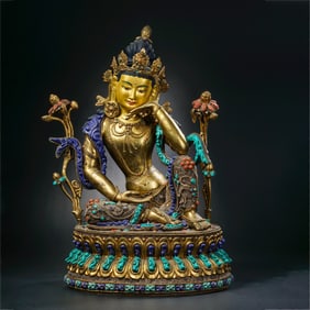 A Chinese Qing Dynasty gilt bronze statue of a seated Buddha inlaid with gemstones