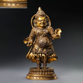 A standing figure of the God of Wealth, a gilt bronze statue inlaid with turquoise, dating from the