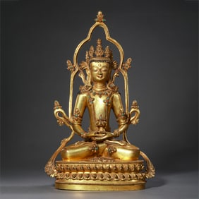 A Chinese Ming Dynasty gilt-bronze seated Buddha statue inlaid with gemstones