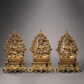 A Chinese Qing Dynasty gilt bronze and turquoise-inlaid seated figure of the Three Buddhas
