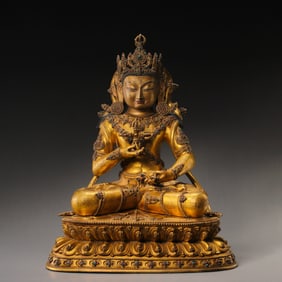 A Chinese Ming Dynasty gilt-bronze seated Buddha statue inlaid with gemstones