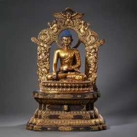 A Chinese Ming Dynasty gilt bronze statue of a seated Buddha