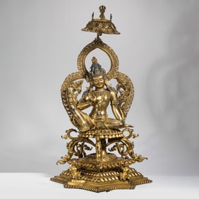 A Chinese Ming Dynasty gilt bronze and turquoise-inlaid seated Buddha statue
