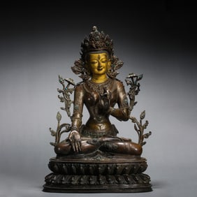 A partially gilt bronze, gem-inlaid seated Buddha statue from the Qing Dynasty, China
