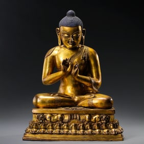 A Chinese Ming Dynasty gilt bronze statue of a seated Buddha