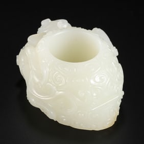 A Chinese Qing Dynasty Hetian white jade heart-shaped pendant with a dragon pattern