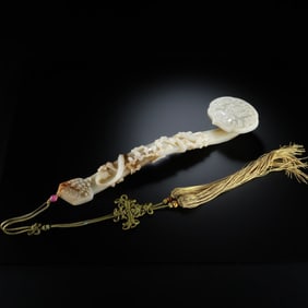 A Chinese Qing Dynasty Hetian white jade carved Ruyi ornament