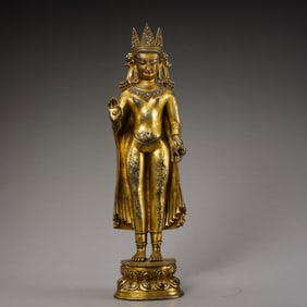 A Chinese Ming Dynasty gilt-bronze standing Buddha statue inlaid with gemstones