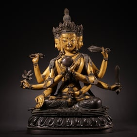 A partially gilded bronze statue of a seated Buddha from the Qianlong period of the Qing Dynasty,