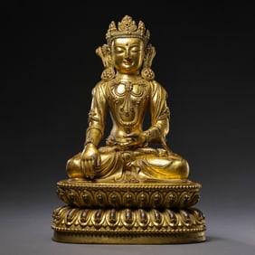 A Chinese Ming Dynasty gilt bronze statue of a seated Buddha
