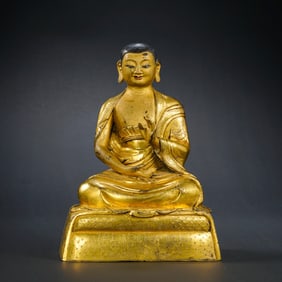 A Chinese Ming Dynasty gilt bronze statue of a seated Buddha