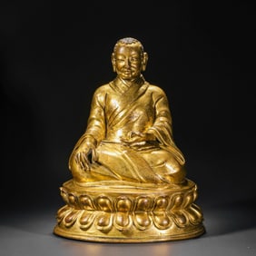 A Chinese Ming Dynasty gilt bronze statue of a seated Buddha