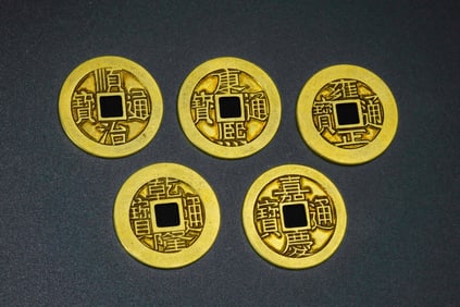 A set of pure gold coins from the Qing Dynasty of China, featuring five emperors.