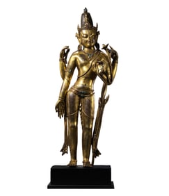 A 15th-century Chinese gilt bronze standing Buddha statue in the Mara style.