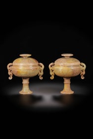 A pair of Chinese Han Dynasty double-dragon-eared high-footed covered censers