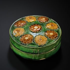 Chinese Tang Dynasty tricolor glazed pottery box with applied floral patterns.