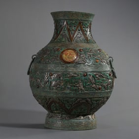 A round pot with double ring handles inlaid with gold and silver from the Warring States period of