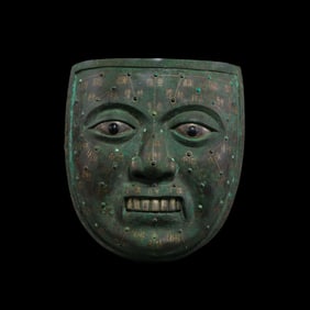 Acupuncture face with gold and silver inlay and turquoise from the Warring States period of China.