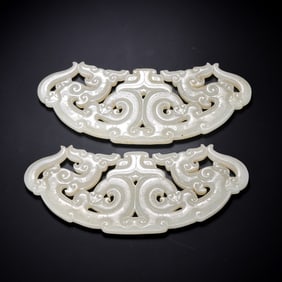 A pair of Chinese Han Dynasty white jade double dragon pendants