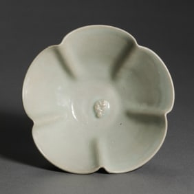 A moon-white glazed cup with applied floral design from the Yaozhou kiln during the late Tang and