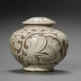 A white-glazed covered jar with carved floral patterns from the Cizhou kiln during the late Tang and