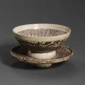 A set of Chinese Tang Dynasty black and white glazed marbled cups and saucers