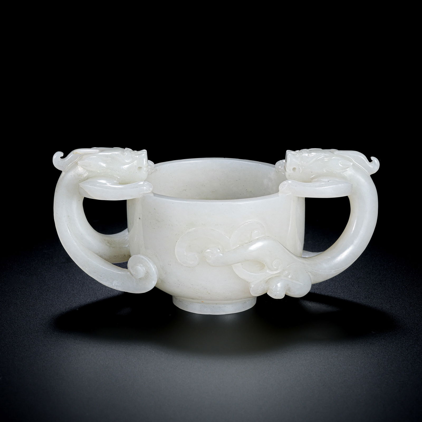 Chinese Qing Dynasty Hetian white jade double-eared cup: H. 6.5 cm. L. 13 cm. Weight. 333.1 gram.
