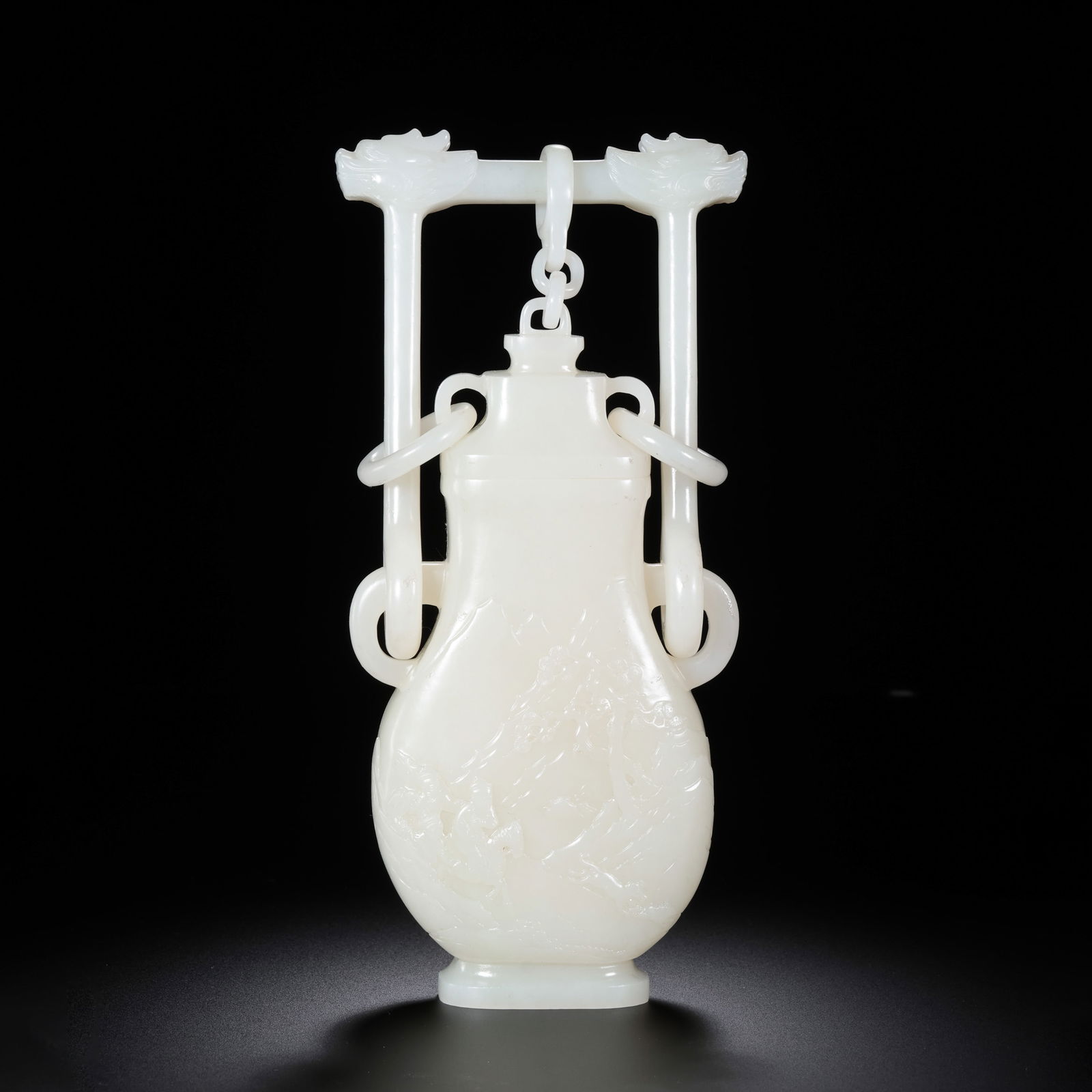 Chinese Qing Dynasty Hetian white jade covered vase with handle and ring ears: H. 22 cm. W. 10.5 cm. Weight. 683 gram.