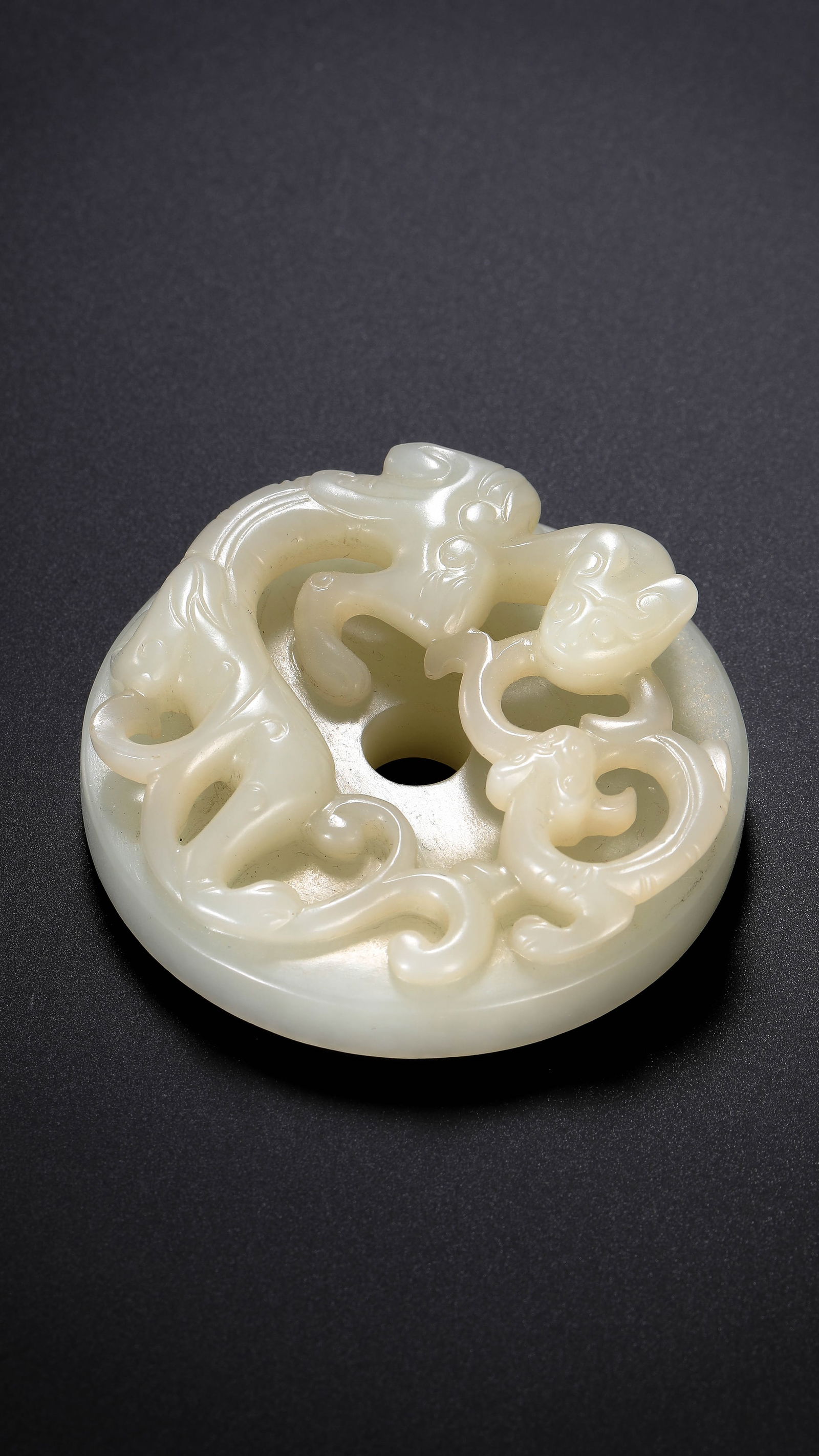 Chinese Han Dynasty white jade dragon-shaped bi disc (1 of 12)