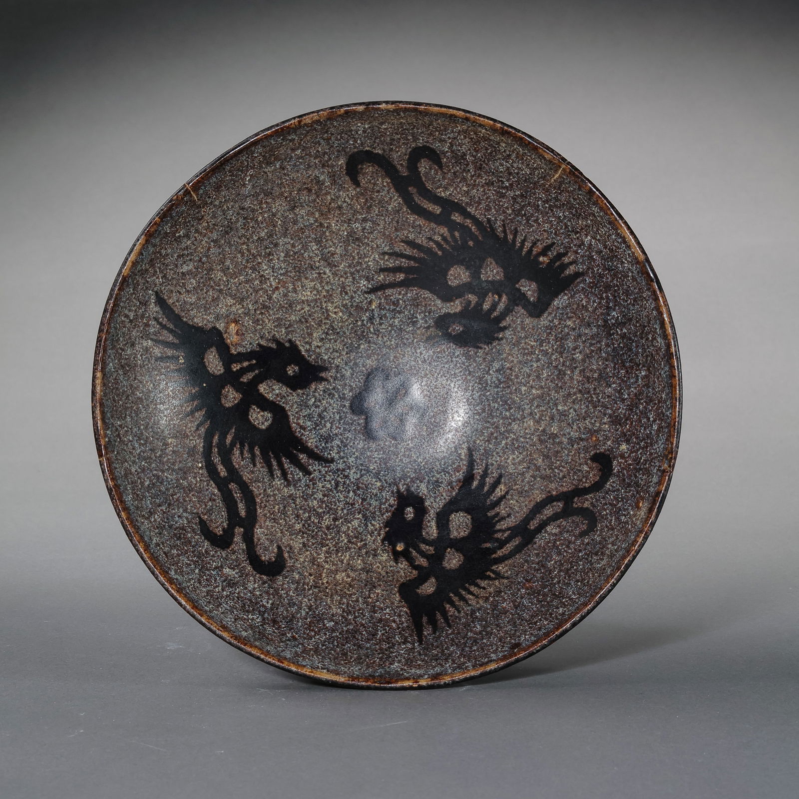 A paper-cut appliqué three-phoenix pattern conical cup from the Jizhou kiln of the Southern Song: H. 5.5 cm. Diam. 15.2 cm.