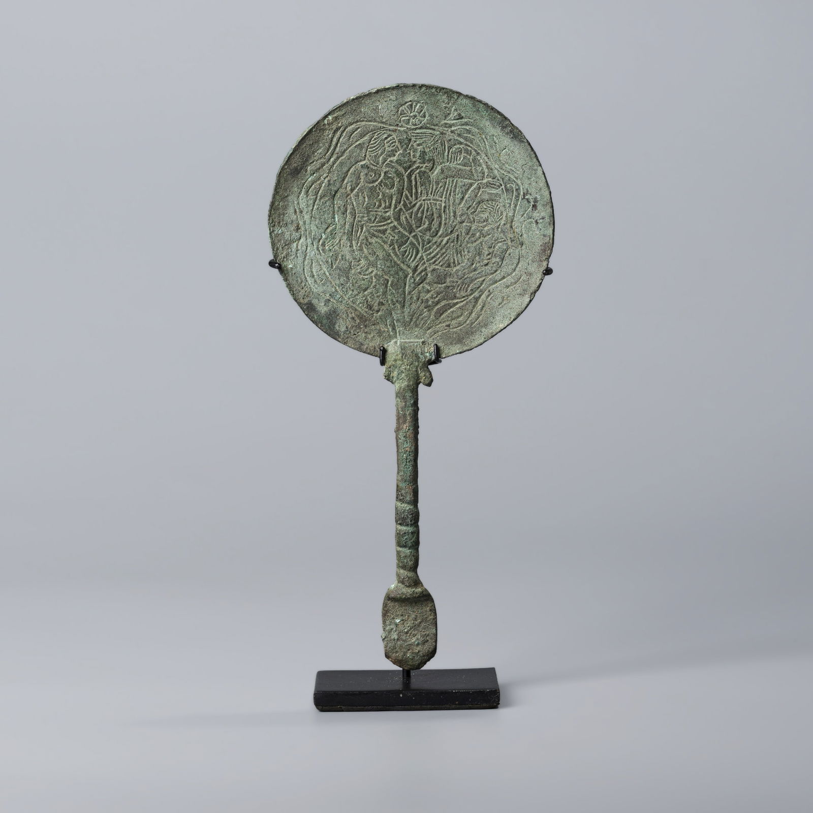 Near Eastern Bactrian Bronze Mirror with Engraved Story Scene and Ornate Handle: H. 22.6 cm. W. 10.8 cm. Weight. 113 gram.