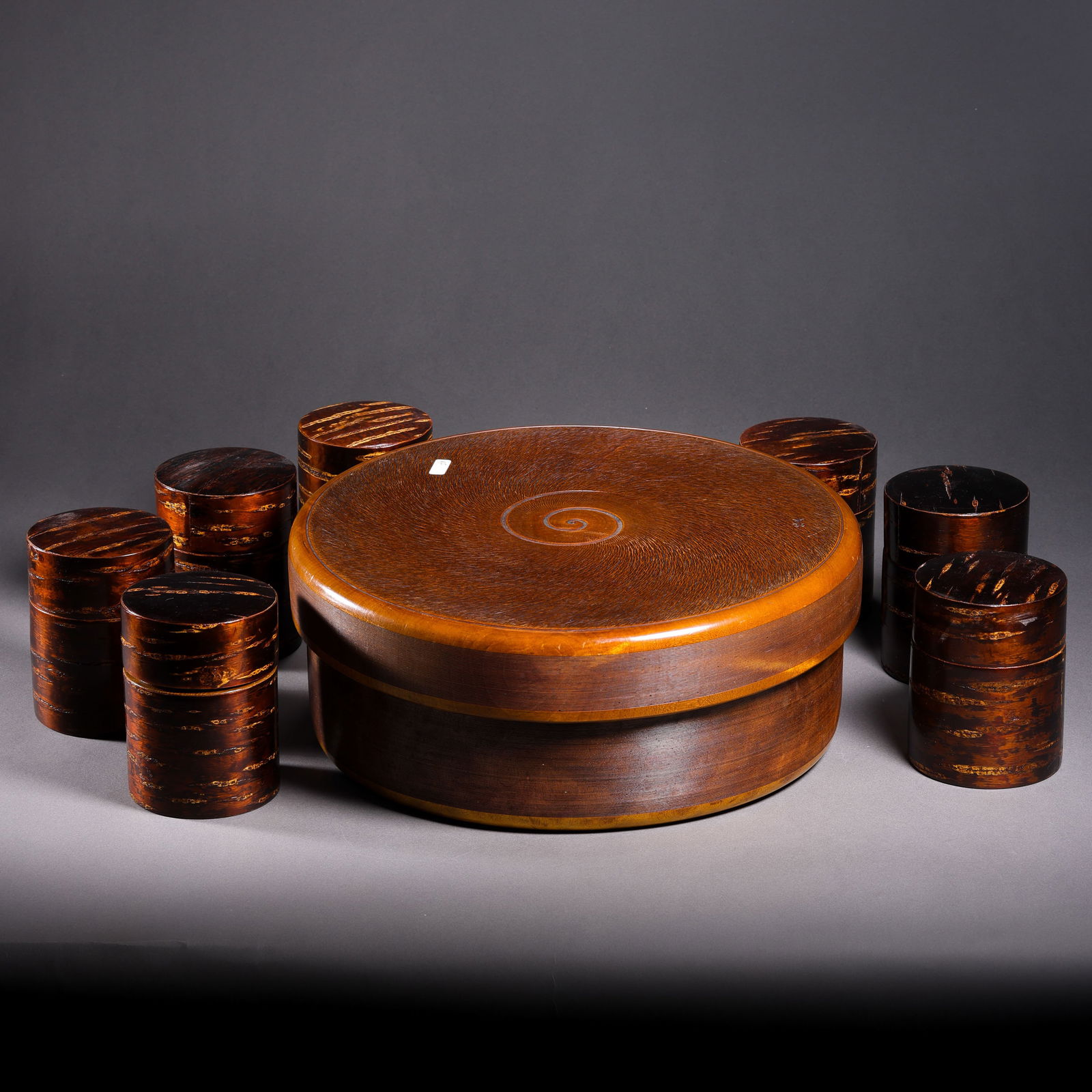 A set of Chinese Qing Dynasty huanghuali wood covered boxes: H. 12 cm. Diam. 28 cm. H. 9.8 cm. Diam. 7.5 cm.