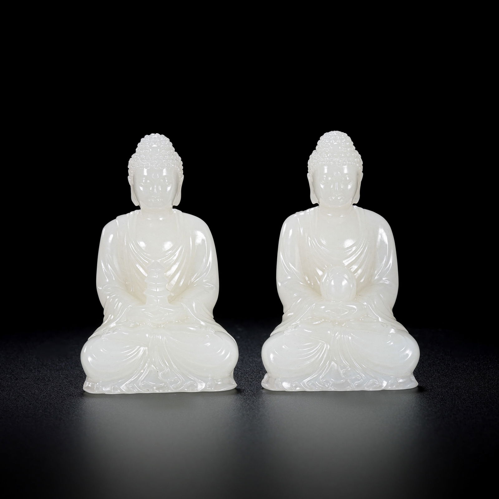 A pair of Chinese Qing Dynasty Hetian white jade seated Buddha statues: H. 7 cm. W. 4 cm. Weight. 161.3 gram.