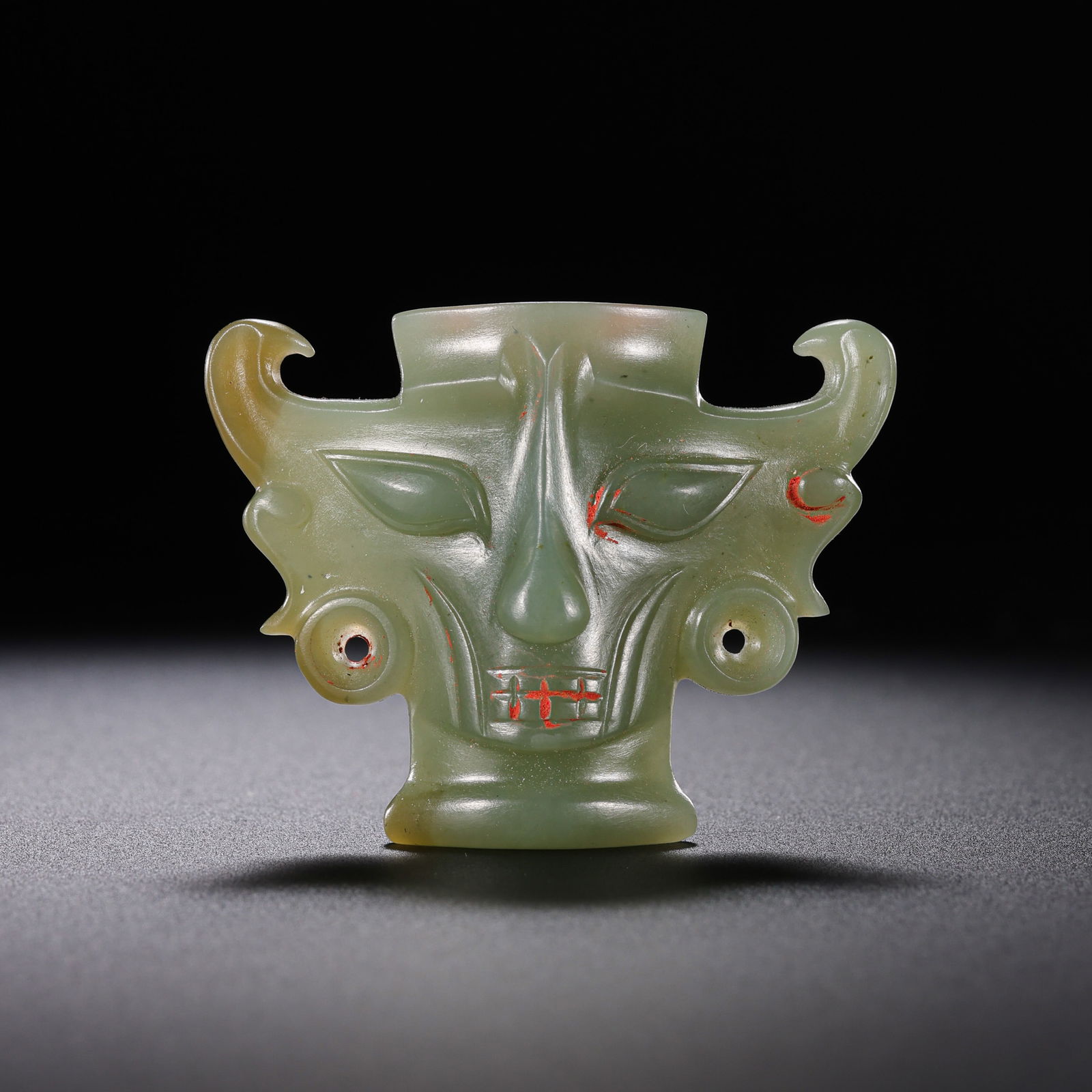 Jade human face from the Western Zhou Dynasty in China: L. 5.1 cm. W. 4 cm. Weight. 25 gram.