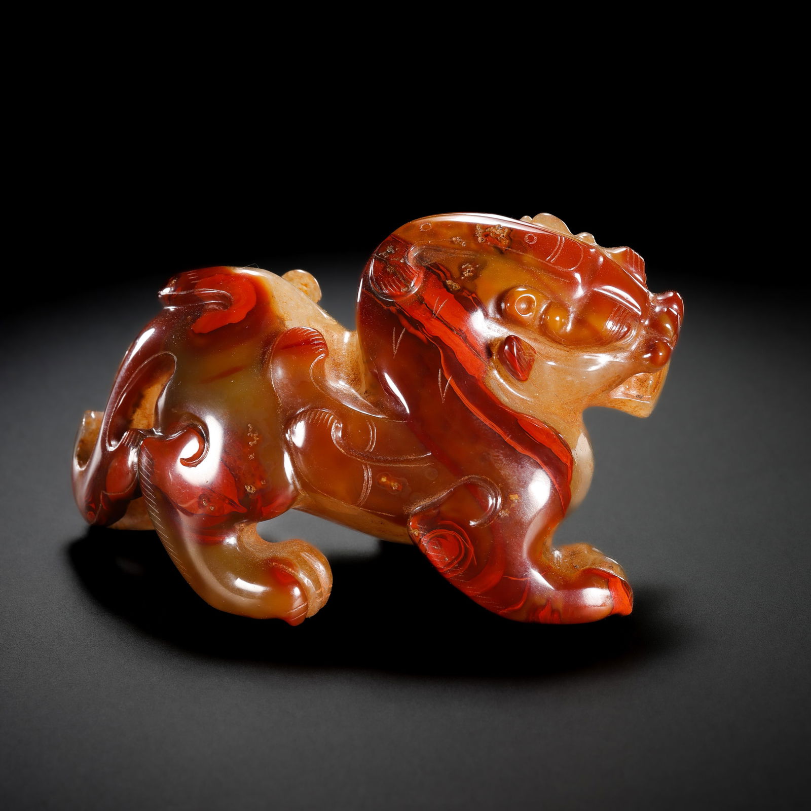 Red agate auspicious beast from the Warring States period in China: H. 6.5 cm. L. 10.8 cm. Weight. 344 gram.