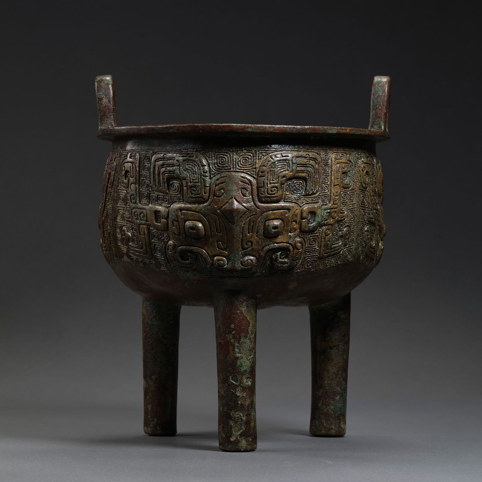 Chinese Shang and Zhou Dynasty bronze three-legged double-eared censer: /